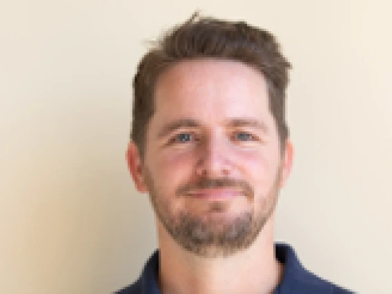 Man wearing a navy blue polo