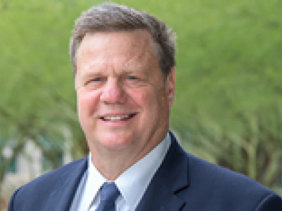 Man wearing a blue suit and blue tie