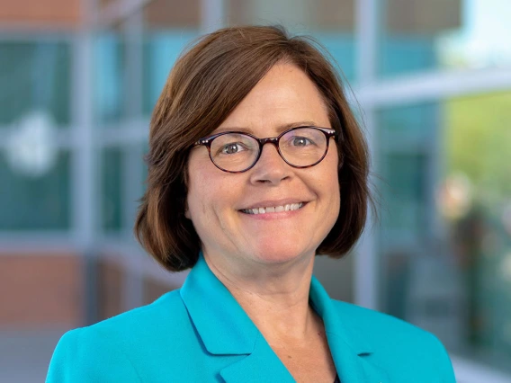 Woman with glasses wearing a light blue jacket